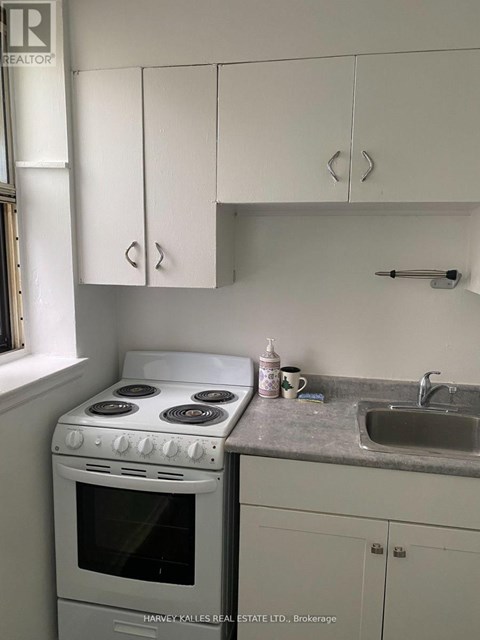 A white stove and sink in a kitchen.