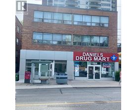 A Daniel's Drug Mart storefront with a sign that reads 1584.