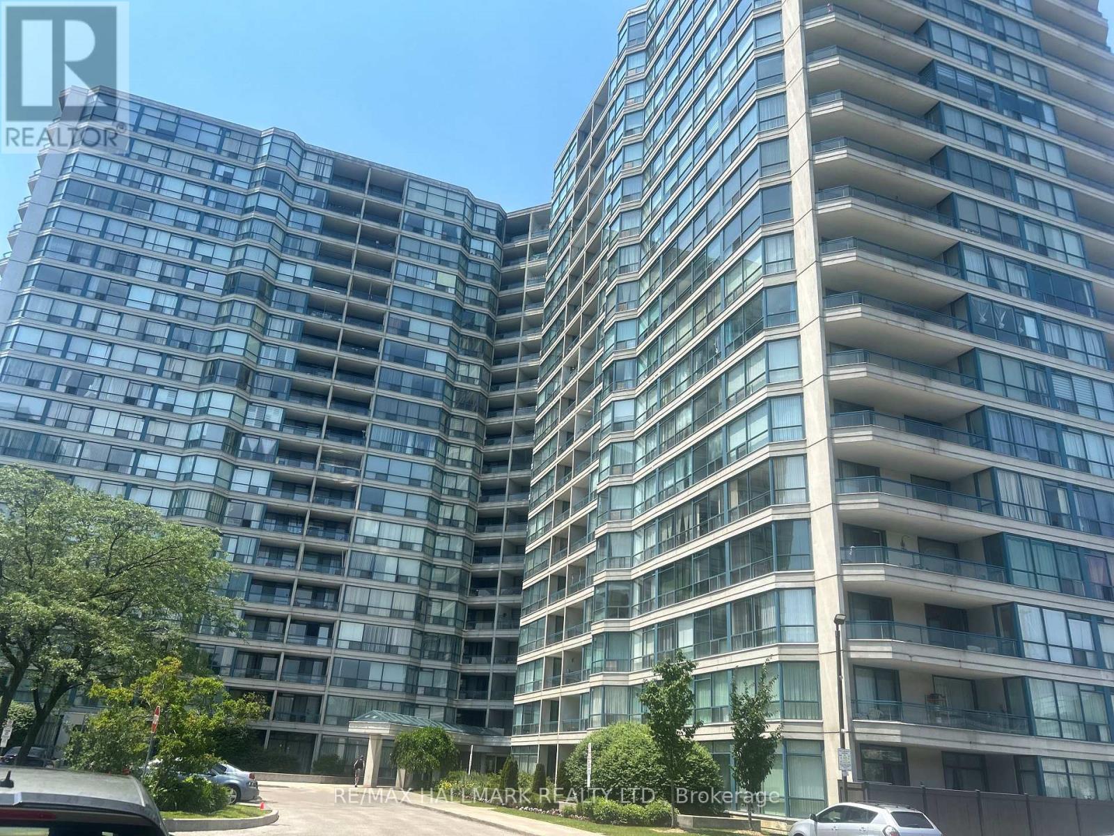 A tall residential building with many windows and balconies.