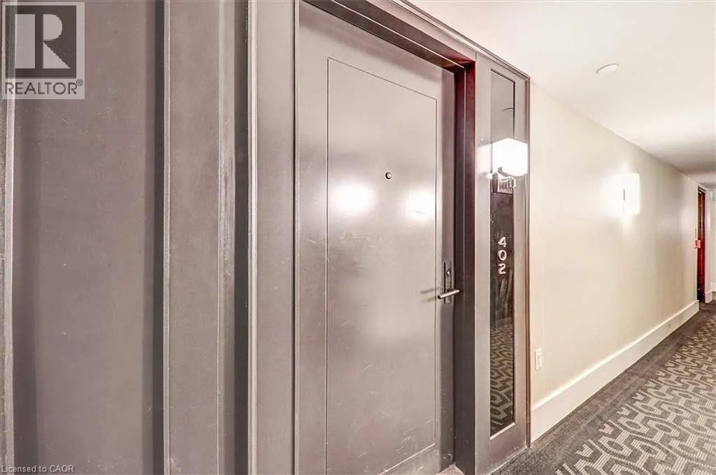 A hallway with a door on the right and a sign on the wall.