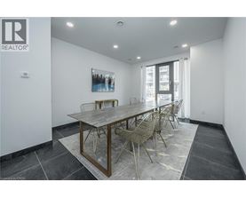 A dining room with a wooden table and chairs.