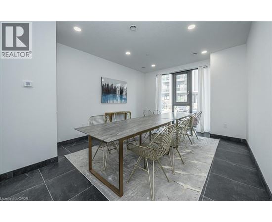 A dining room with a wooden table and chairs.