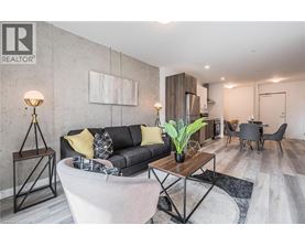 A living room with a grey couch and a wooden coffee table.
