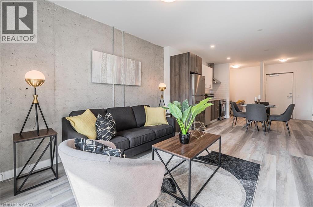 A living room with a grey couch and a wooden coffee table.