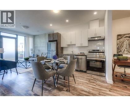 A modern kitchen with a dining table set for four.