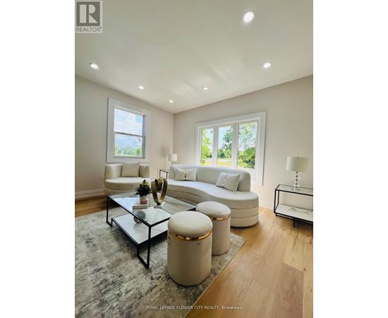 A well-lit, modern living room with a glass coffee table and a white sofa.