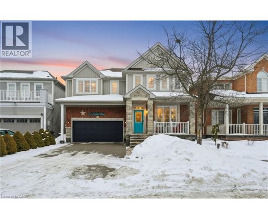 A house with a blue garage door is surrounded by snow.