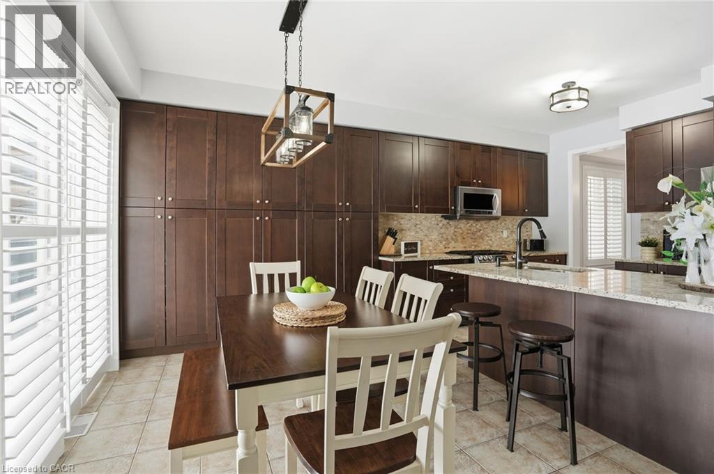 A kitchen with brown cabinets and a wooden table.