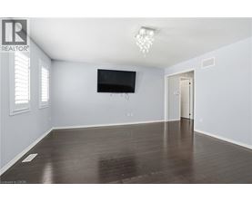 A spacious room with a flat screen TV mounted on the wall.
