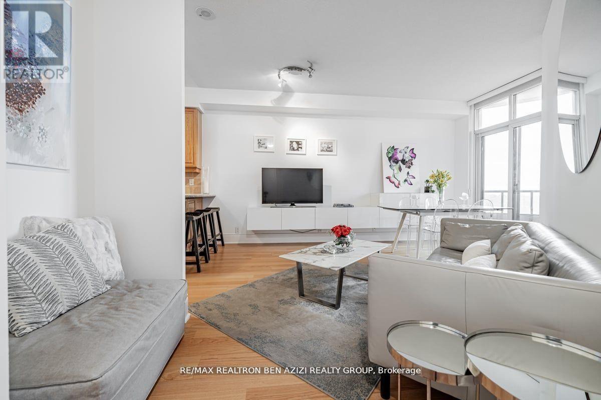 A living room with a grey couch and a white sofa.