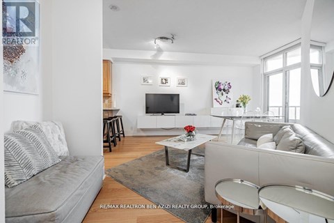 A living room with a grey couch and a white sofa.