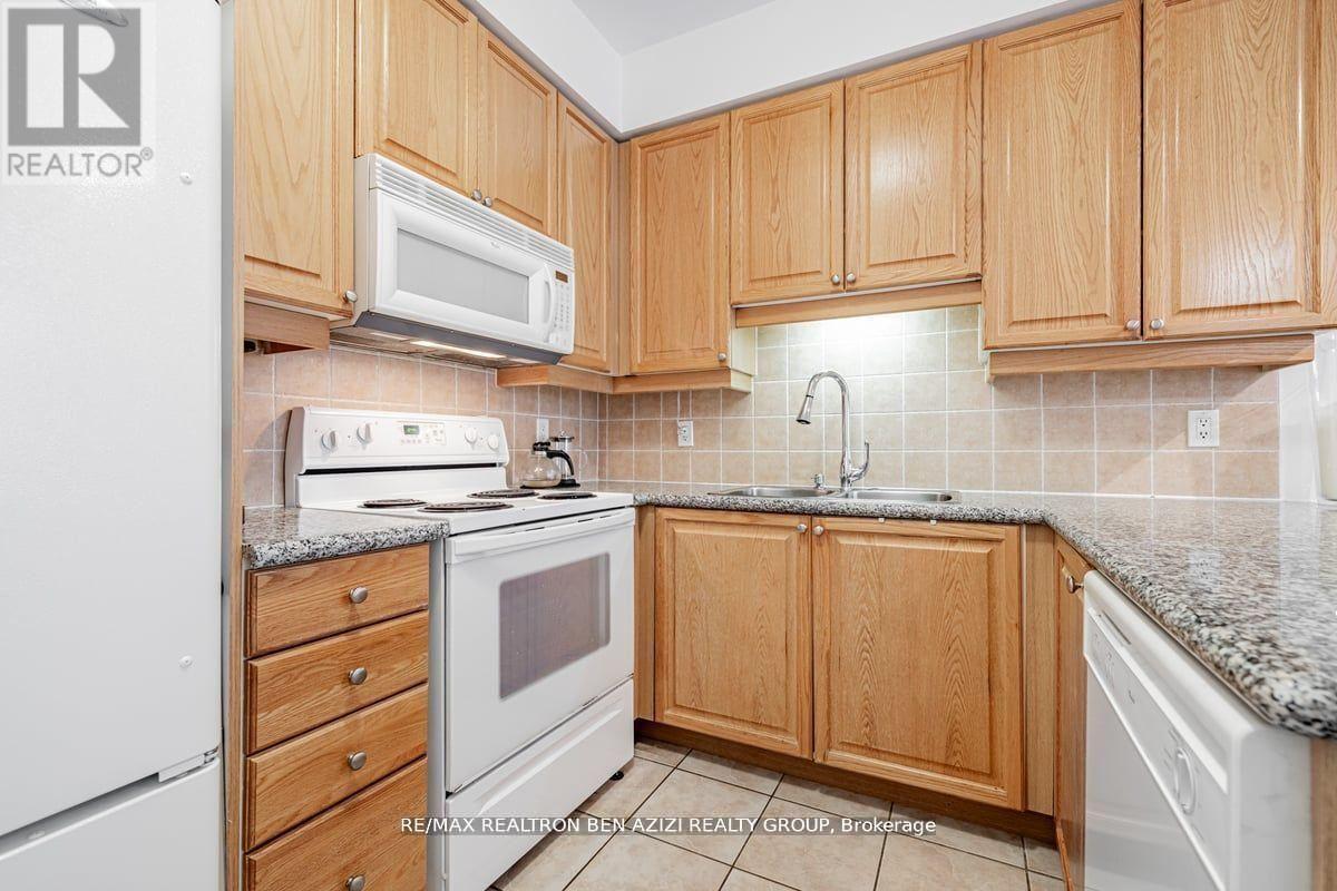 A kitchen with wooden cabinets and a white fridge.