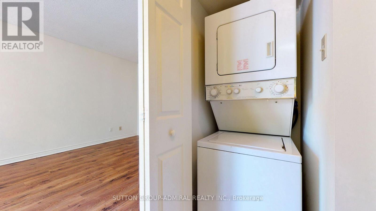 A white oven in a kitchen with wooden flooring.