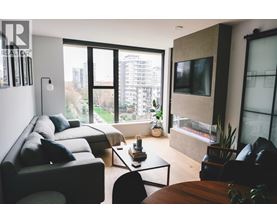 A living room with a couch, a chair, a coffee table, and a television.