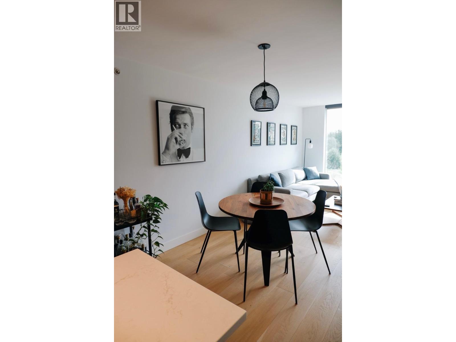 A dining room with a table and chairs.