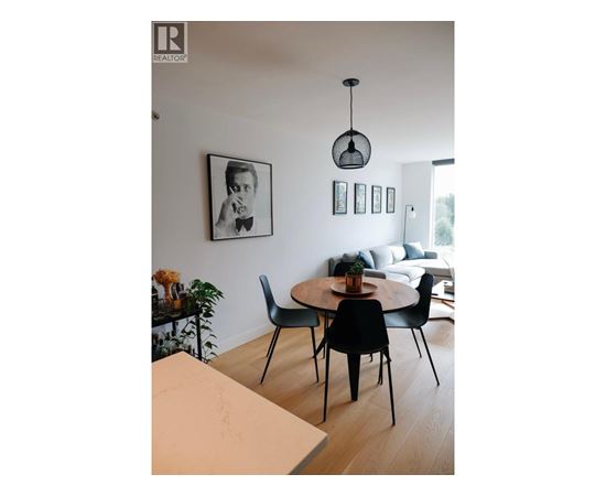 A dining room with a table and chairs.