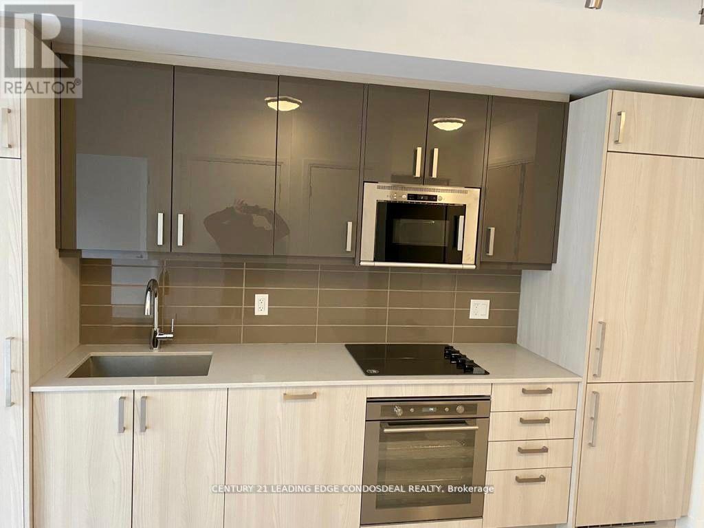 A kitchen with wooden cabinets and a stainless steel oven.