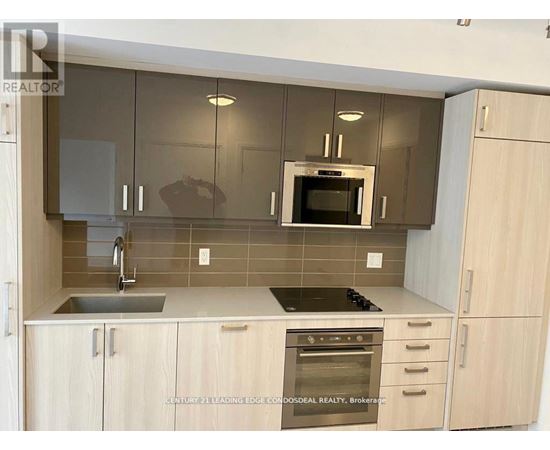 A kitchen with wooden cabinets and a stainless steel oven.