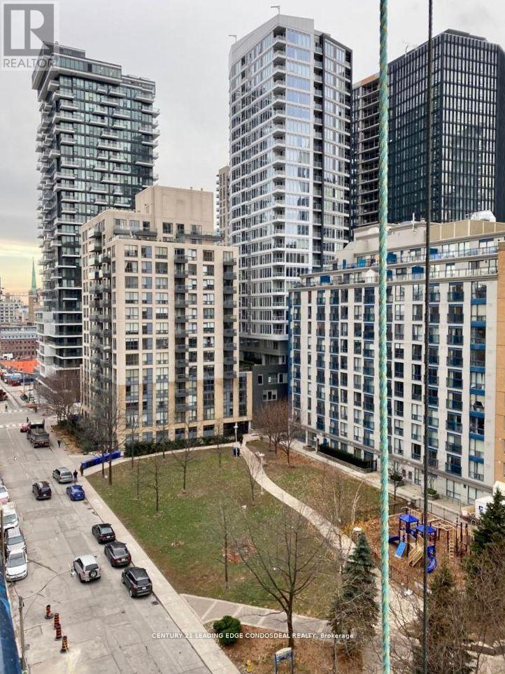 A city street with cars and buildings in the background.