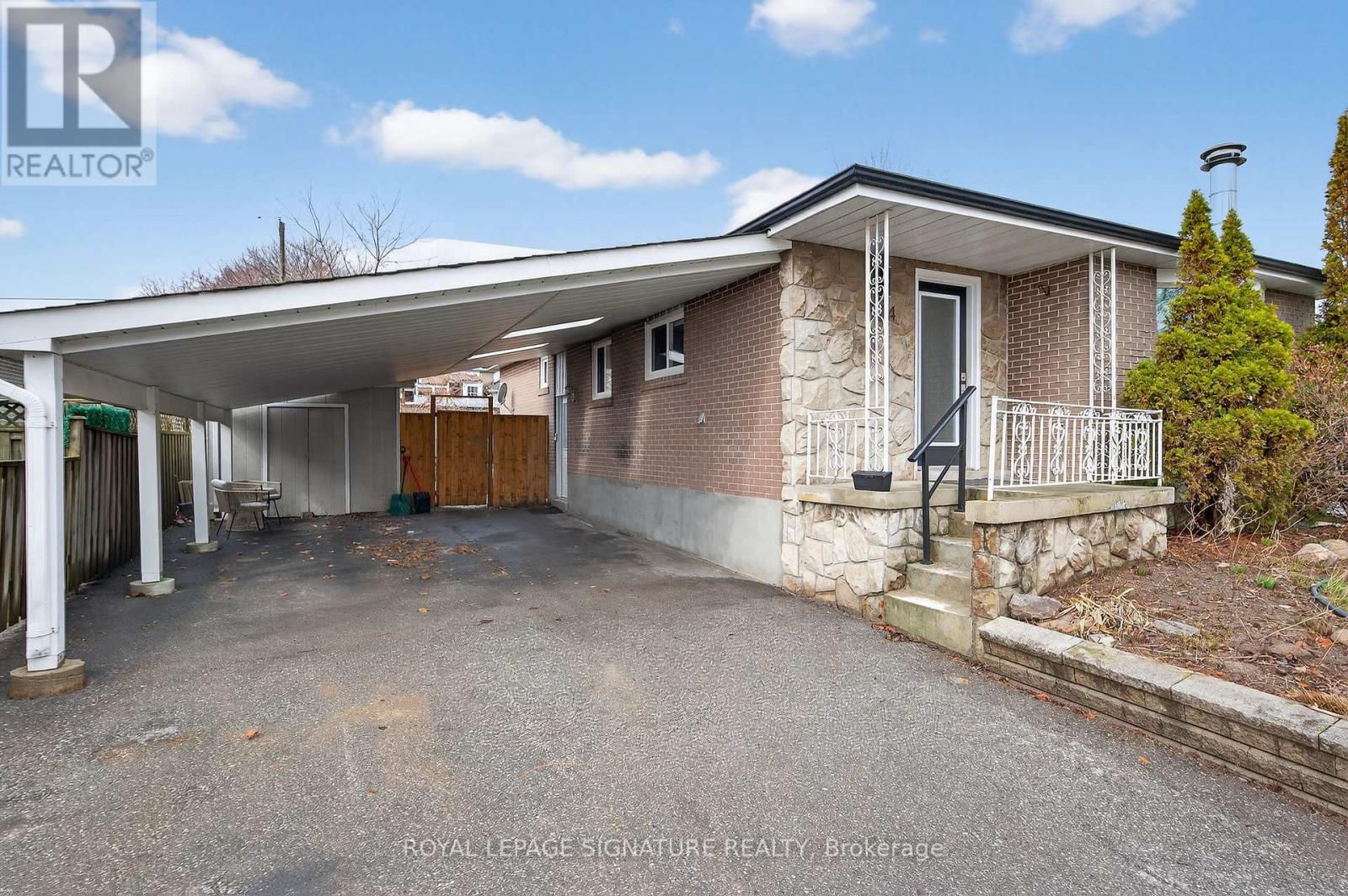 A house with a covered patio and a garage door is for sale.