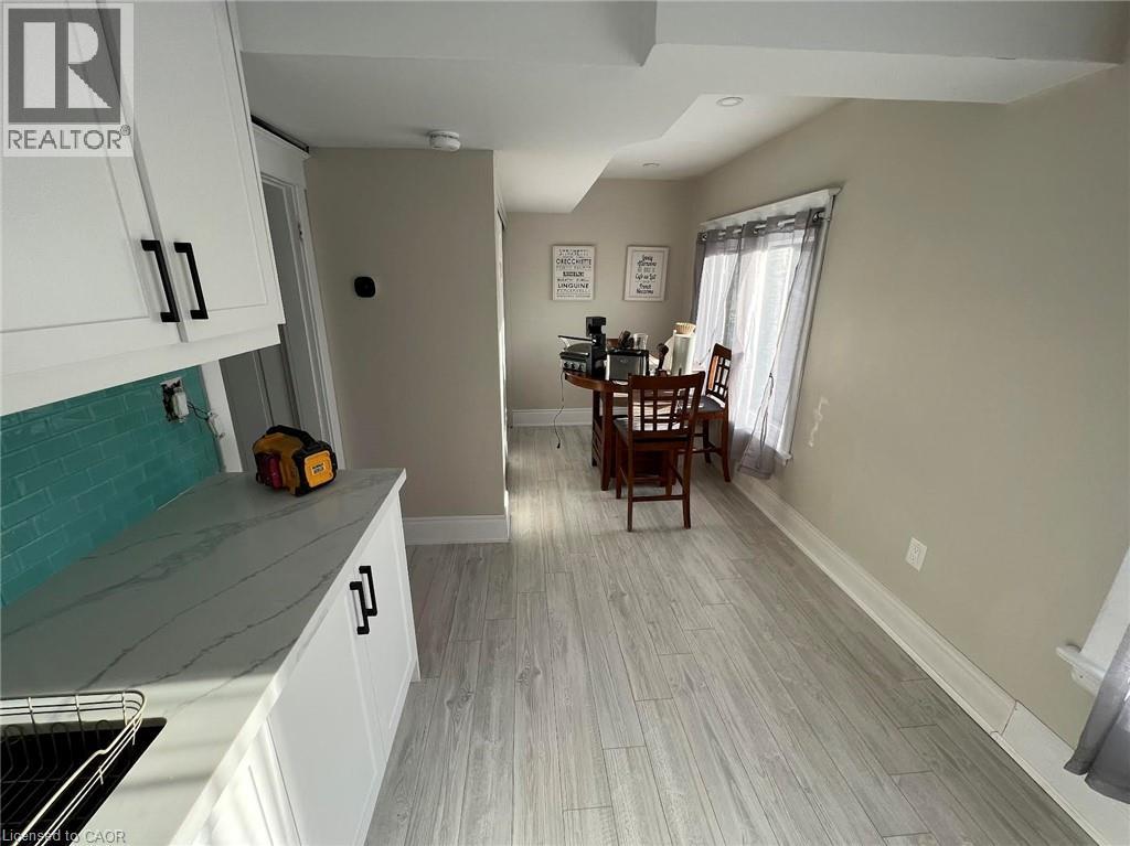 A kitchen with white cabinets and a dining table.