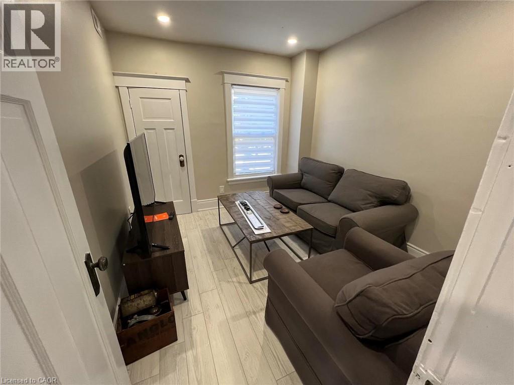 A living room with a brown couch and a flat screen TV.