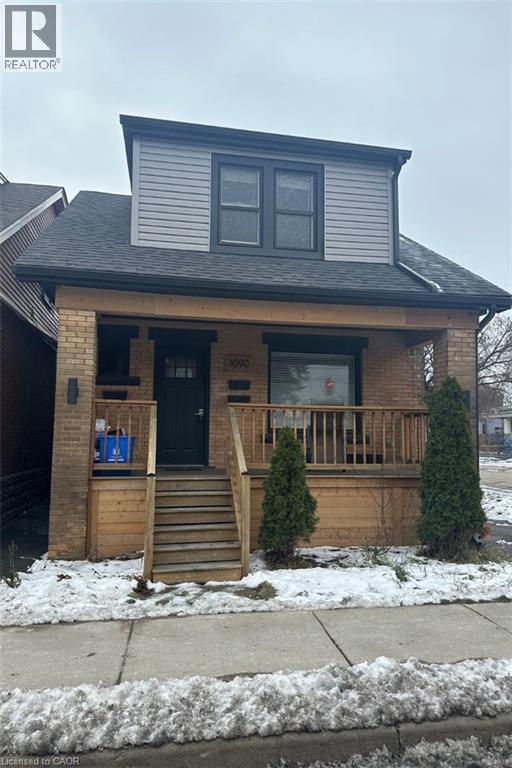 A house with a black front door and a small porch.