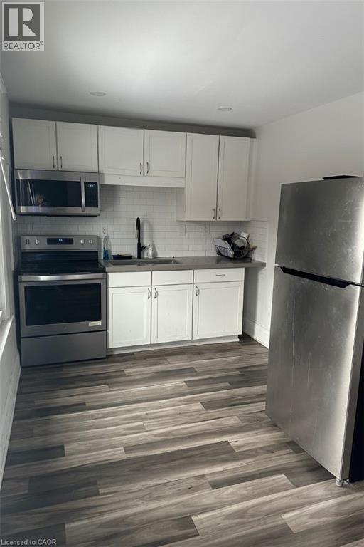 A modern kitchen with a refrigerator on the right.