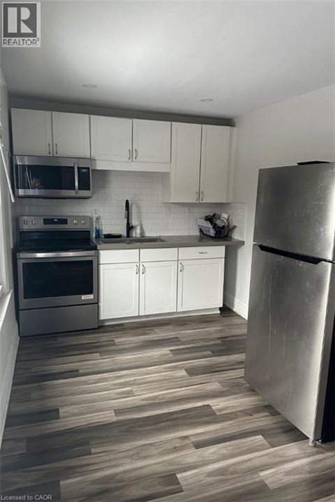 A modern kitchen with a refrigerator on the right.