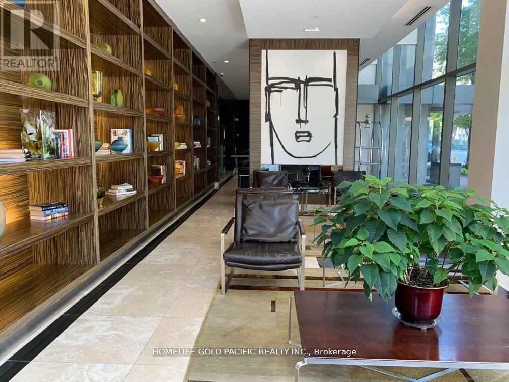 A living room with a large bookshelf and a potted plant.