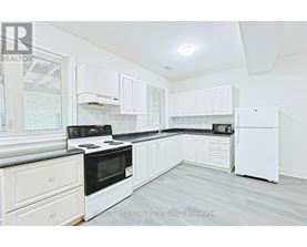 A kitchen with white appliances and cabinets.