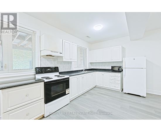 A kitchen with white appliances and cabinets.