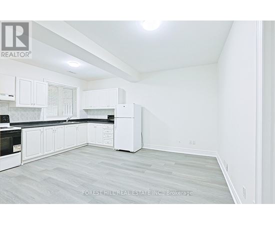 A white kitchen with Forest Hill Real Estate Inc. Brokerage watermark.