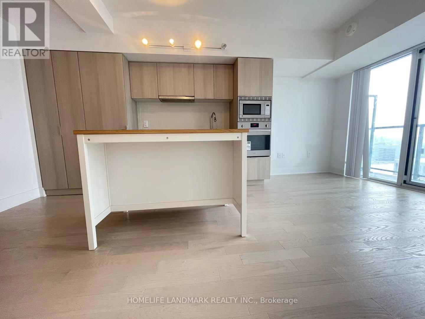 A kitchen with a white island in the middle of the room.