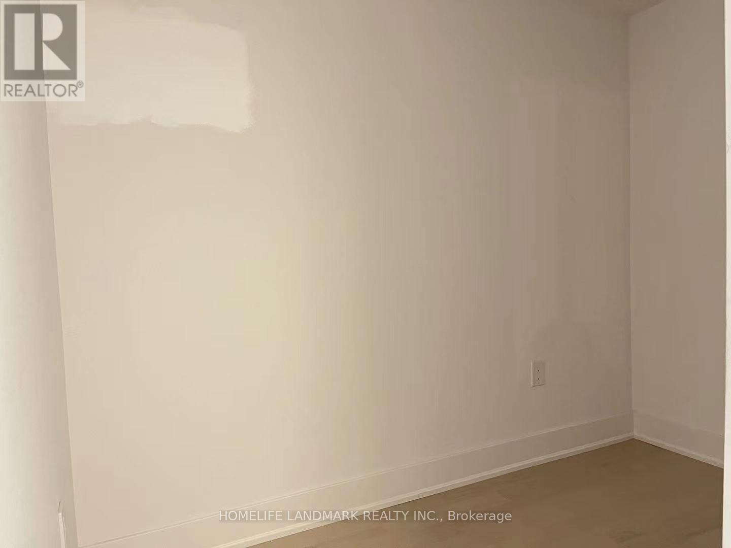 A room with white walls and a wooden floor.