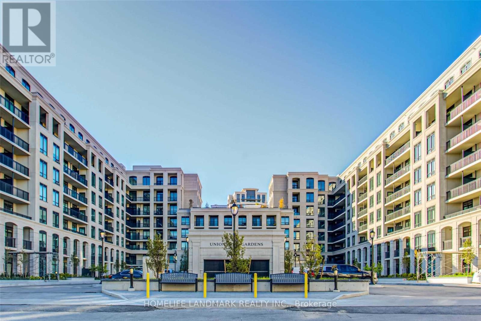A large building with the words "UNITY CROSSINGS" on it is surrounded by other buildings.