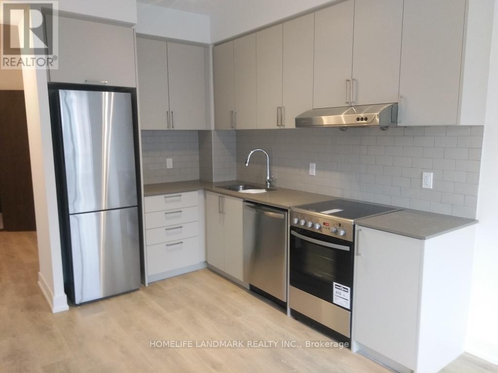 A modern kitchen with stainless steel appliances and white cabinets.