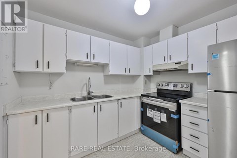 A kitchen with white cabinets and a sink.