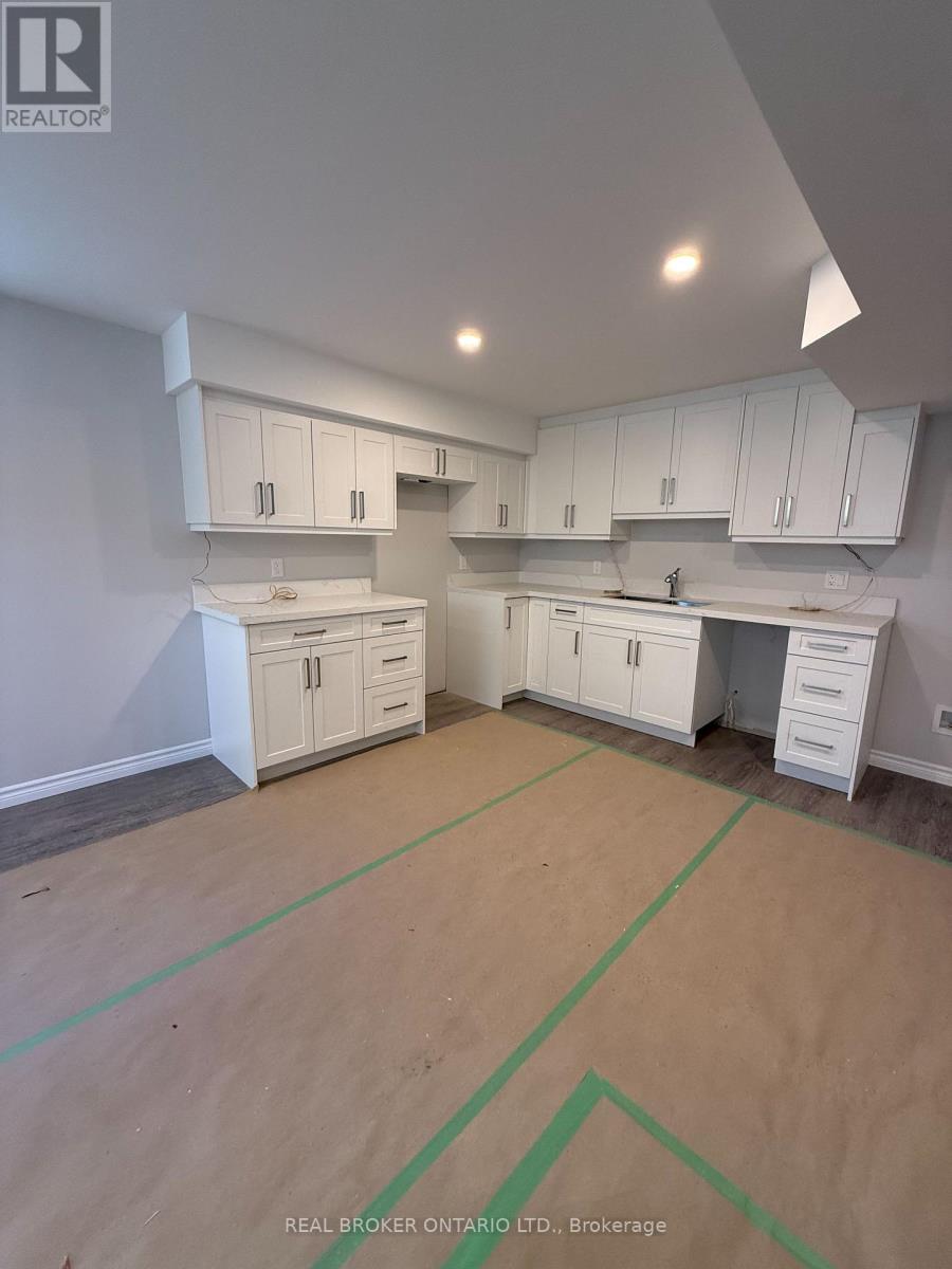 A real estate listing photo of a kitchen under renovation.