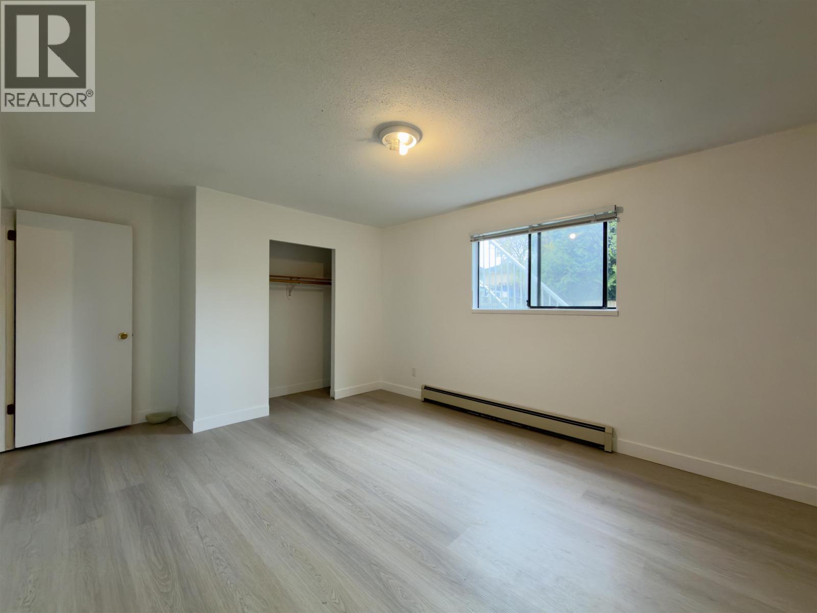 A room with a window and a door.