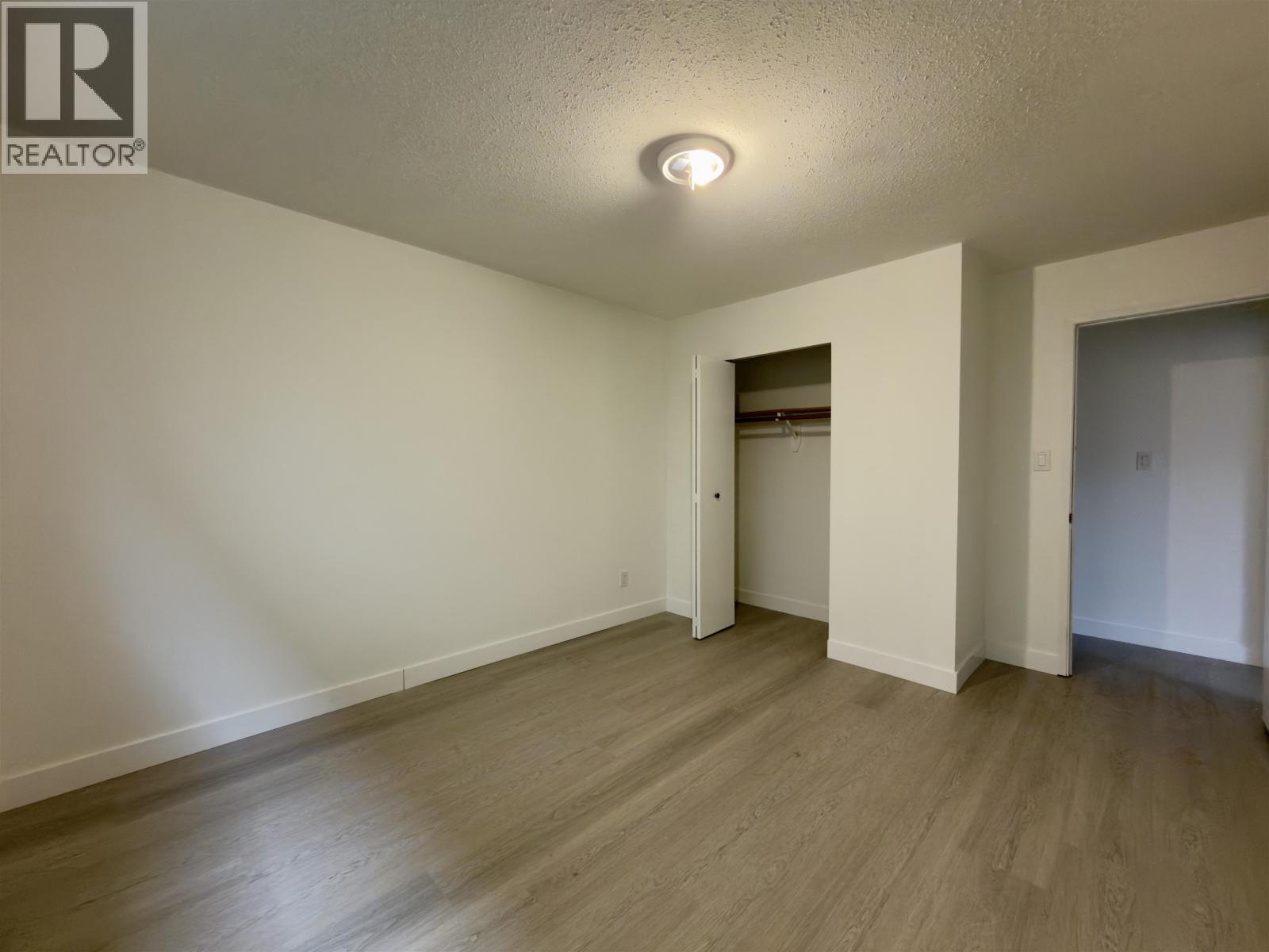 A room with a wooden floor and white walls.