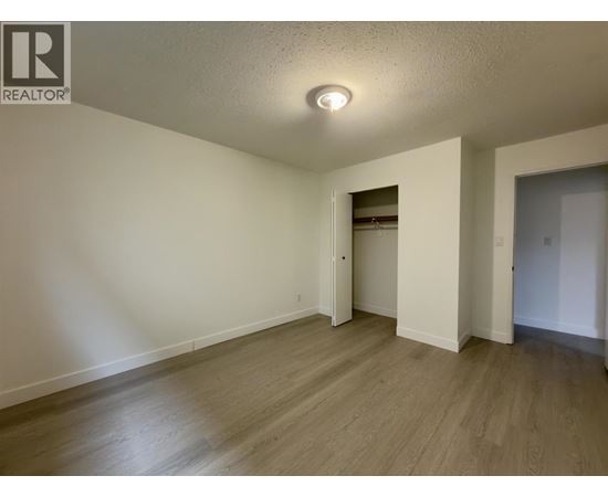 A room with a wooden floor and white walls.