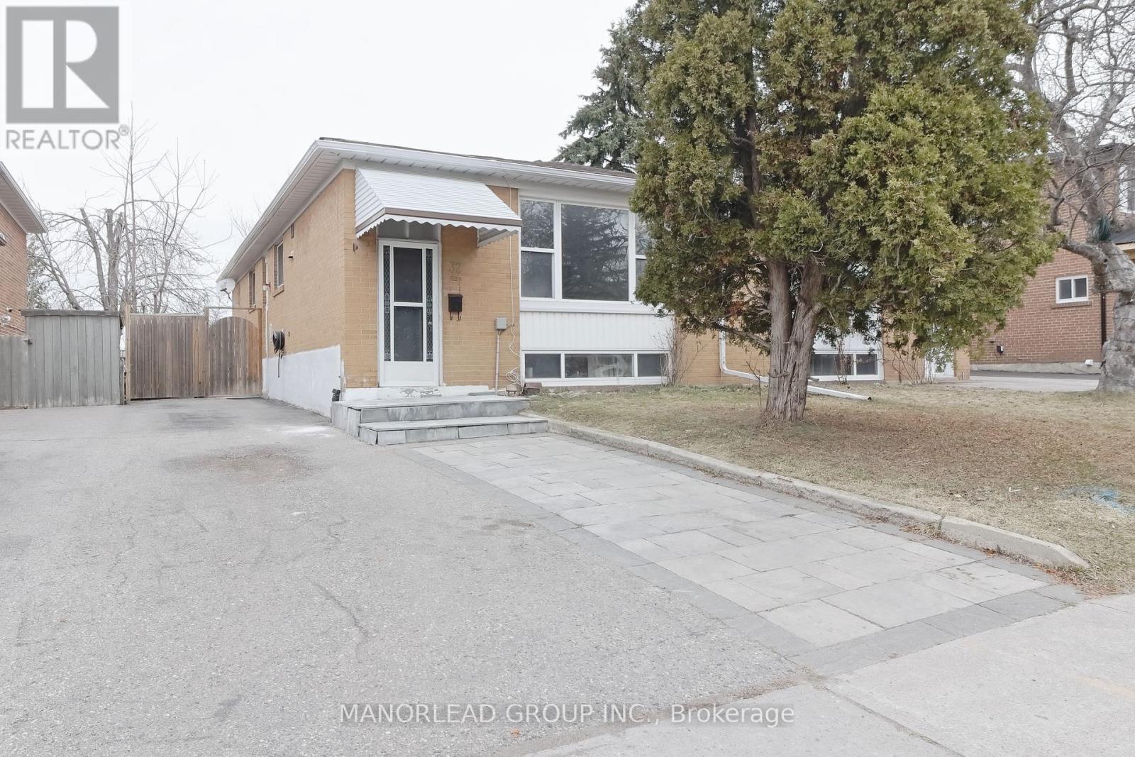 A house with a tree in front of it.