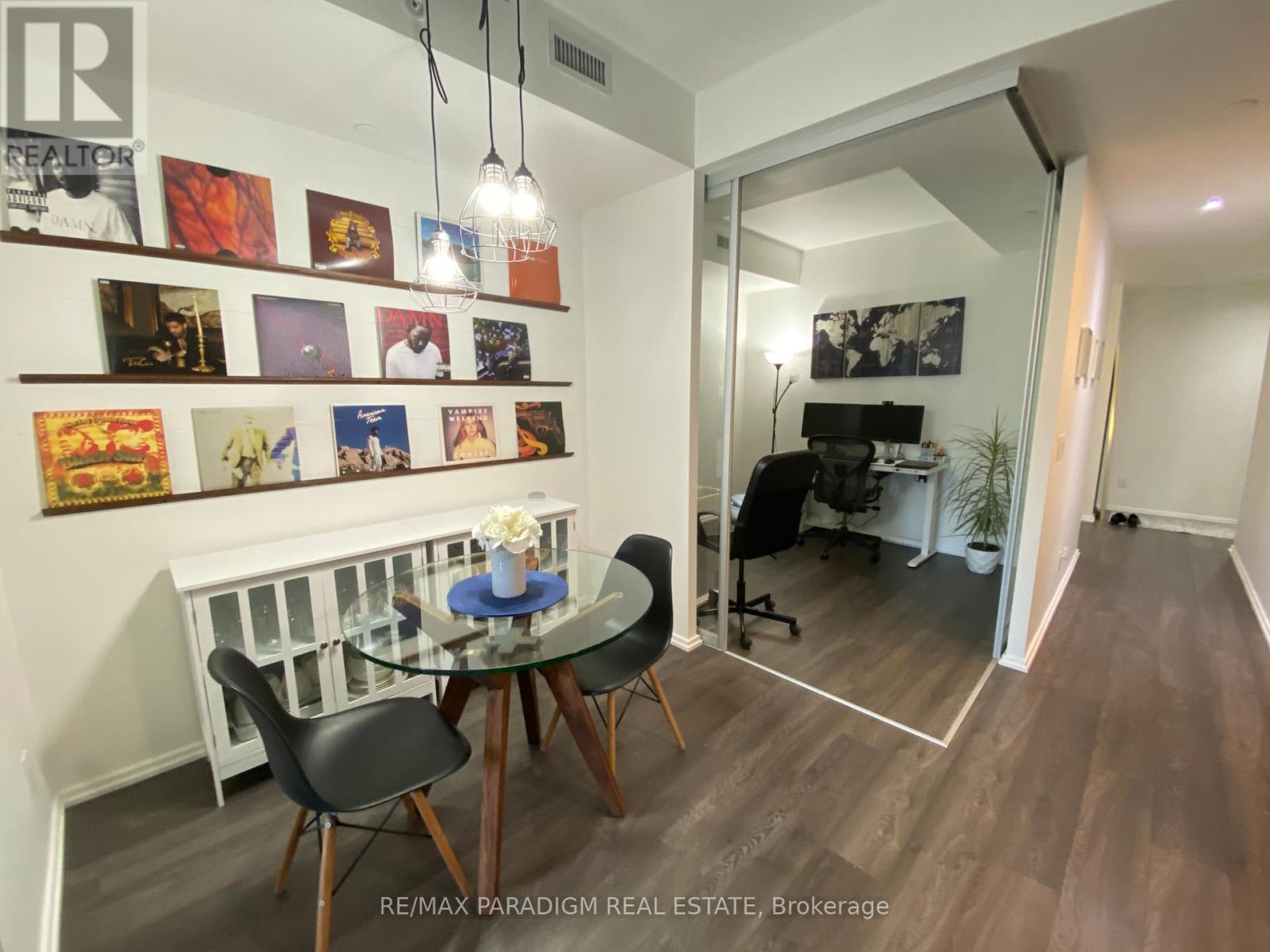 A dining area with a glass table and chairs.