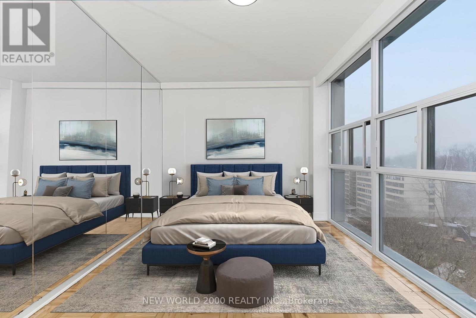 A bedroom with two beds and a large window.