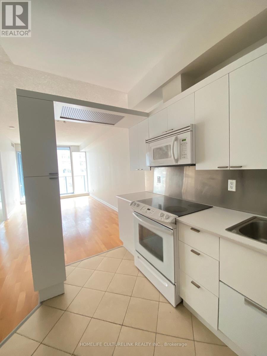A kitchen with white cabinets and appliances is for sale.