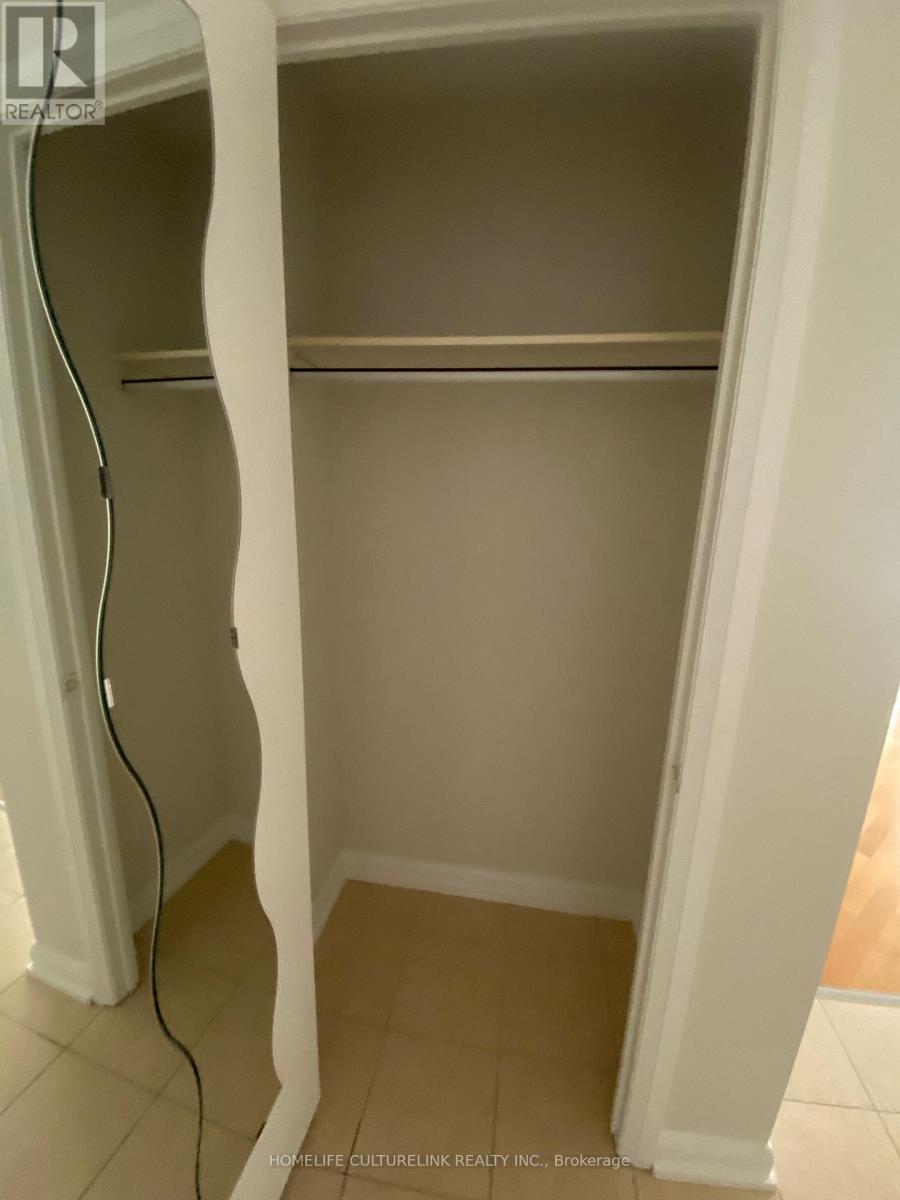 A white closet with a hanger on the left side.