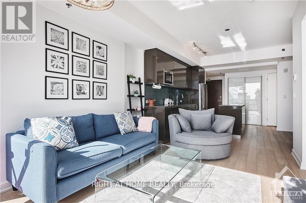 A living room with a blue couch and a glass coffee table.