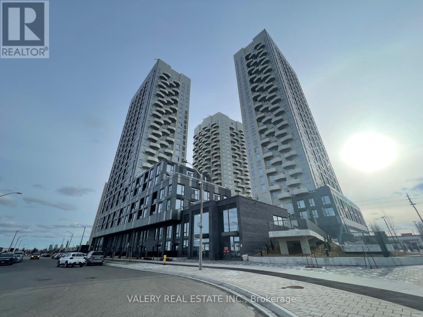 A modern building complex with the logo VALERY REAL ESTATE INC. on the bottom left.