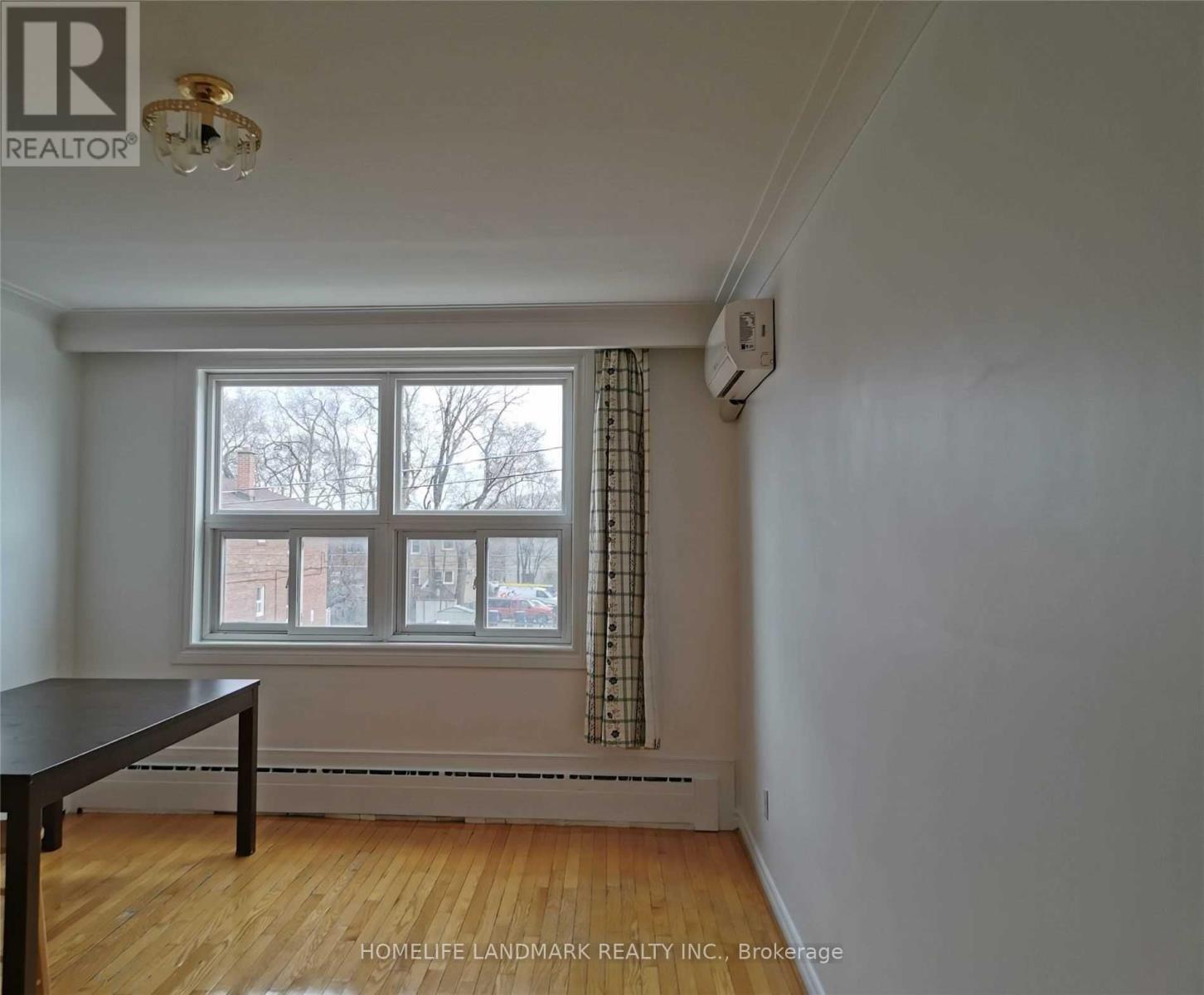 A room with a table and a window.